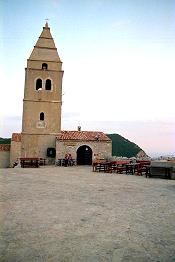 der Glockenturm, Campanile von Lubenice auf der Insel Cres mit alten Fischerhusern in Kroatien